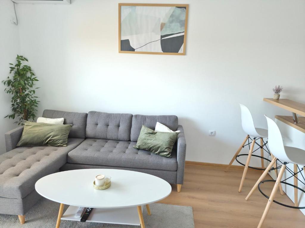 a living room with a couch and a table at Apartman Milos in Modriča