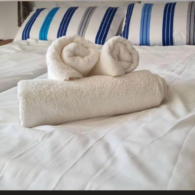 a couple of towels sitting on top of a bed at Fewo in Schwetzingen