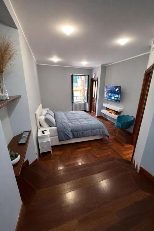 a bedroom with a bed and a television in it at FRASCATI Suites in Frascati
