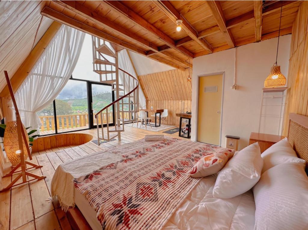 a bedroom with a large bed in a room at Griya Cabin 5 Dieng in Diyeng