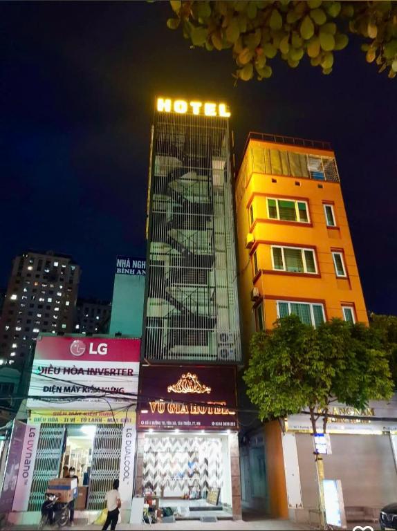 a tall building in a city at night at Vũ Gia Hotel in Hanoi