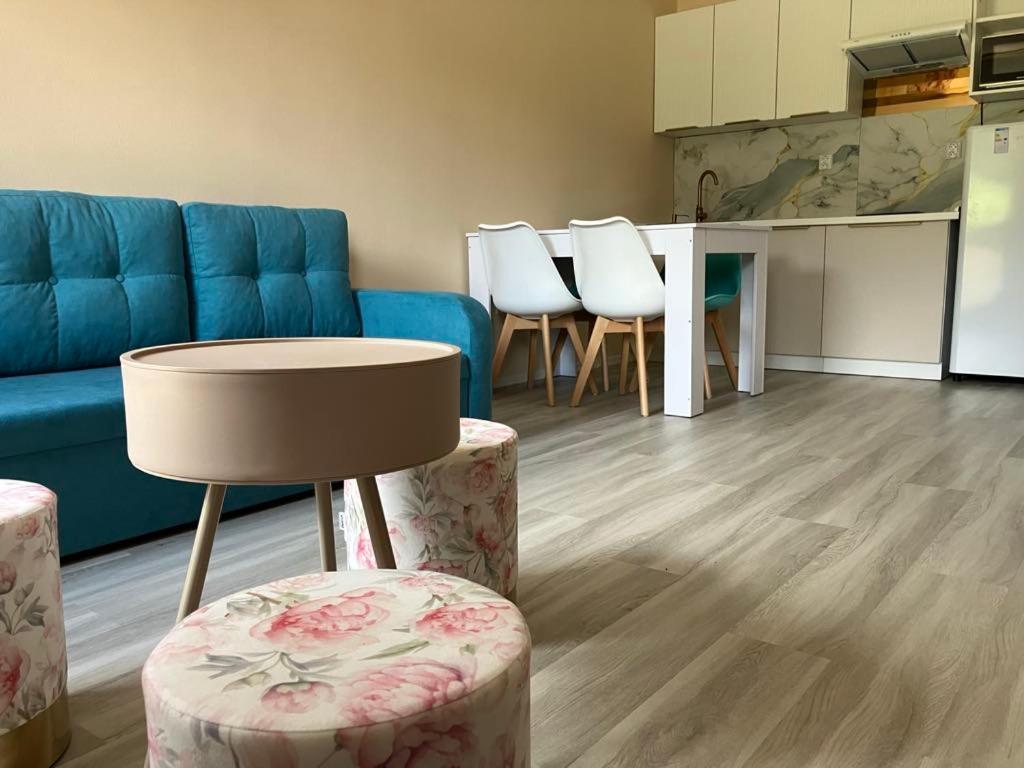 a living room with a blue couch and a table andools at APT 16 Telgart in Telgárt