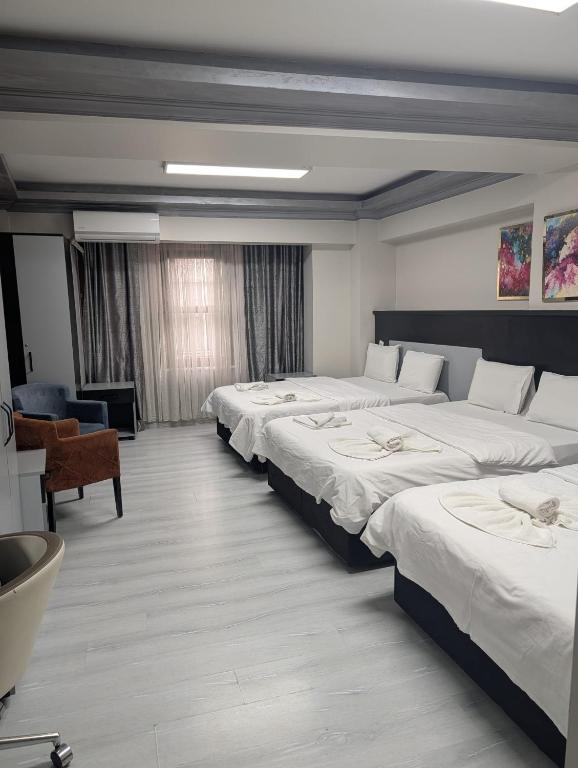 a hotel room with four beds in a row at Retro Boutique in Istanbul