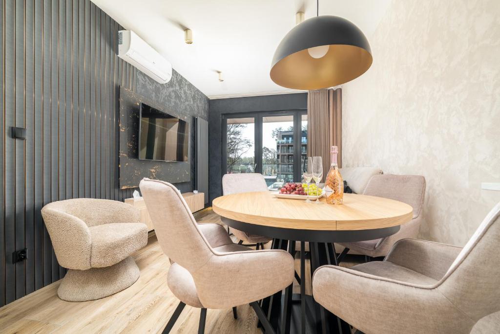 a dining room with a table and chairs at Your Holidays Forest D141 in Międzyzdroje