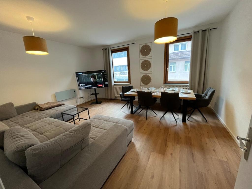 a living room with a couch and a table at City Centre Terrace Apartment in Triberg