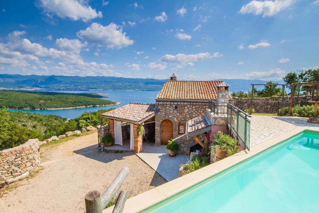 an external view of a house with a swimming pool at Villa Cima in Vrbnik