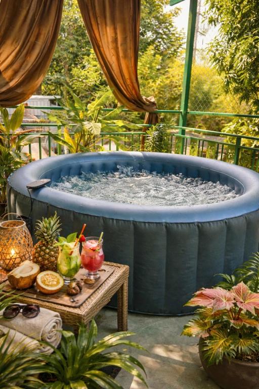 a large hot tub in a garden with a table at House & Spa Tropical Home with Private Jacuzzi Koh Phangan in Ko Phangan