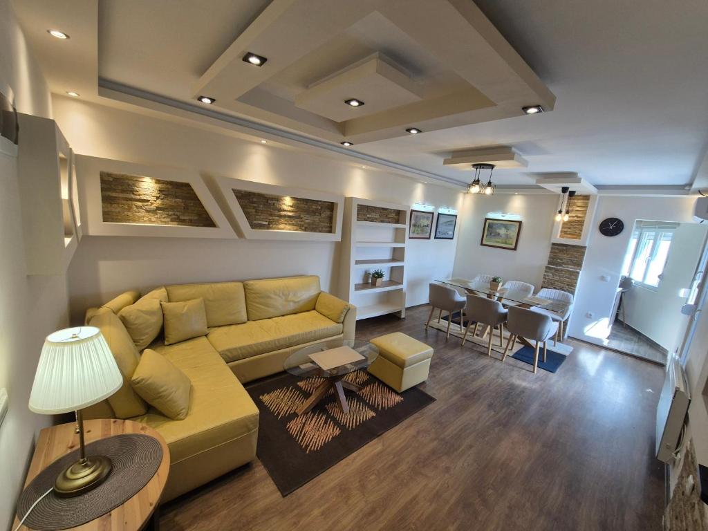a living room with a couch and a dining room at Panorama Apartment in Belgrade