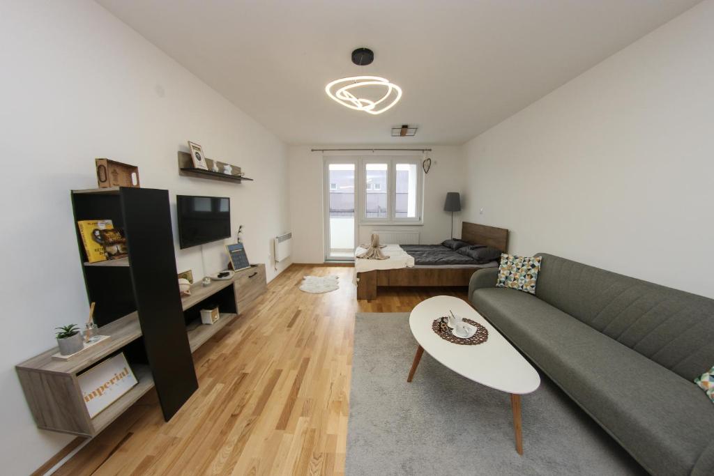 a living room with a couch and a table at Apartman Imperial 7 in Sarajevo