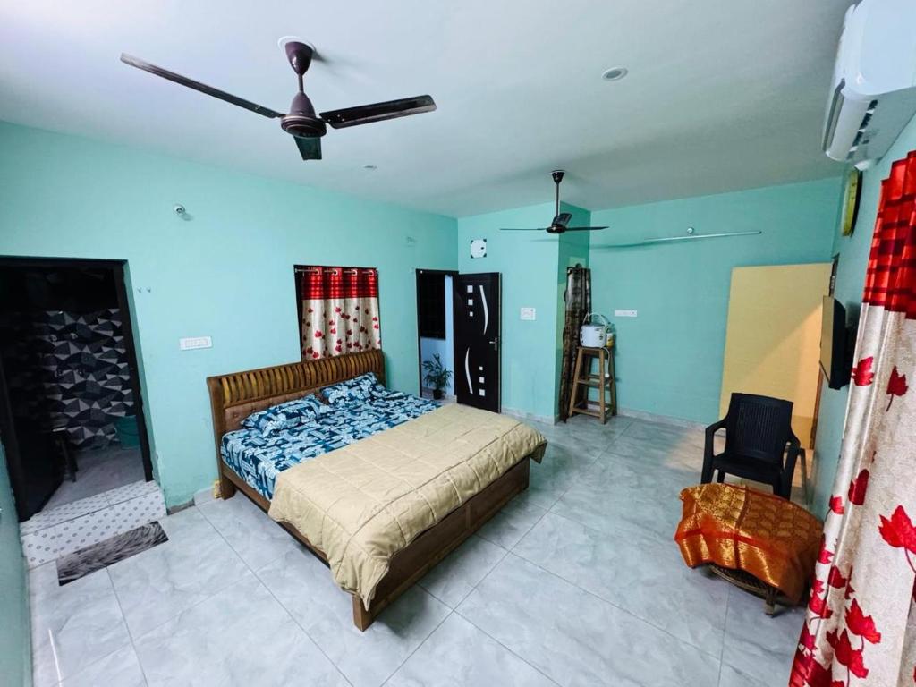 a bedroom with a bed and a ceiling fan at Gravity Groups SP homestay in Pondicherry