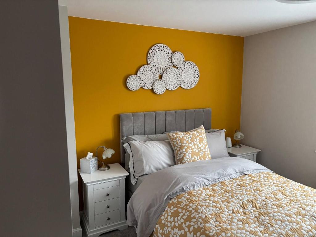 a bedroom with a bed and a yellow wall at Quiet double bedroom in Yapton