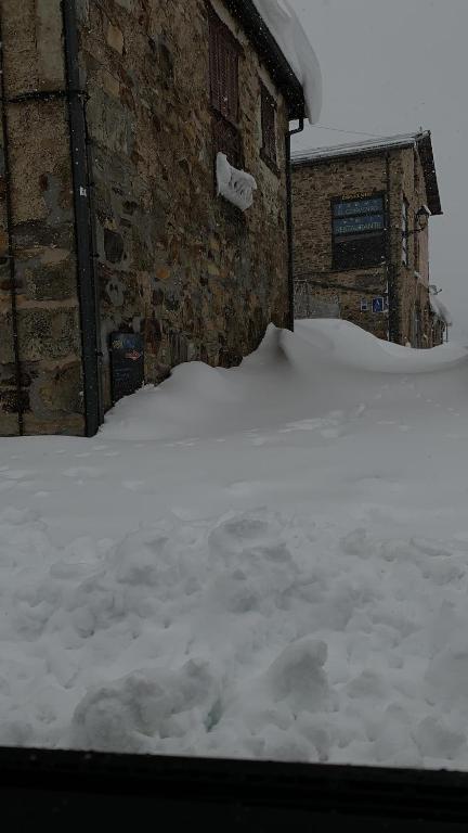 a pile of snow in front of a building at Convento de Foncebadon in Foncebadón