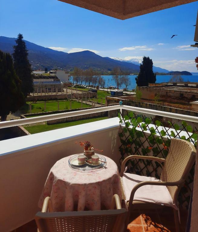 a table and chairs on a balcony with a view at Hana Apartment Ohrid in Ohrid