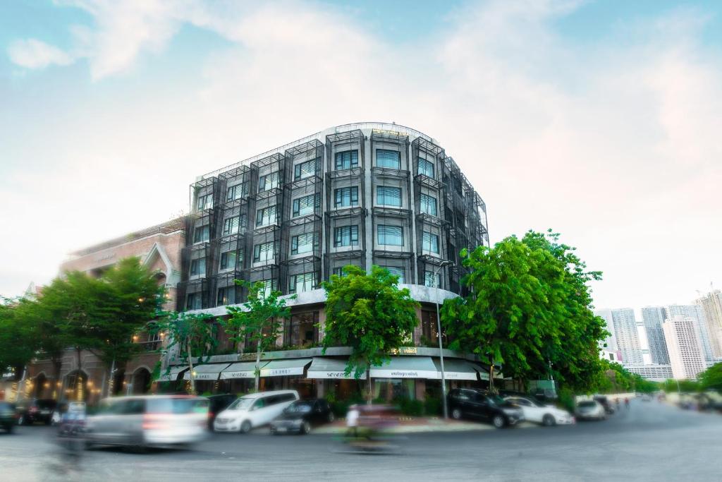 a tall building with cars parked in front of it at Almond Hotel Bassac River in Phnom Penh