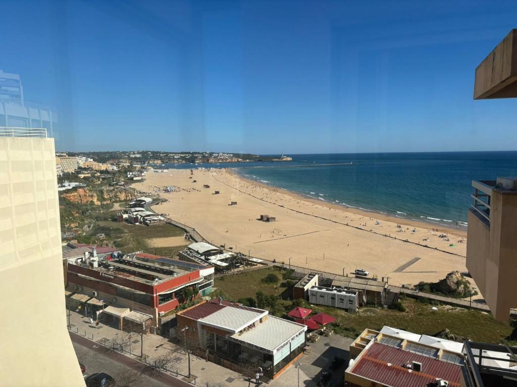 a view of a beach and the ocean from a building at Rocha Atlantico in Portimão
