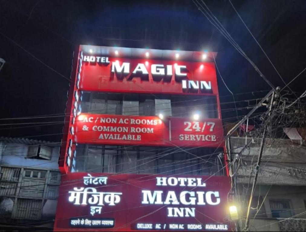 a large building with signs on it at night at Hotel Magic Inn in Nagpur