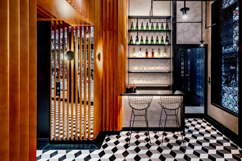 a bar with a black and white checkered floor at Oootopia West in Hong Kong