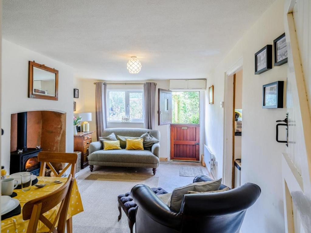 a living room with a couch and a table at 2 Bed in Crediton oc-79431 in Sandford