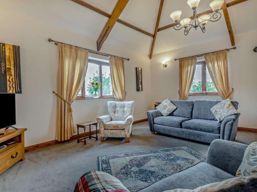 a living room with a couch and a chair at 3 Bed in Holsworthy oc-tcsheph in Merryfield
