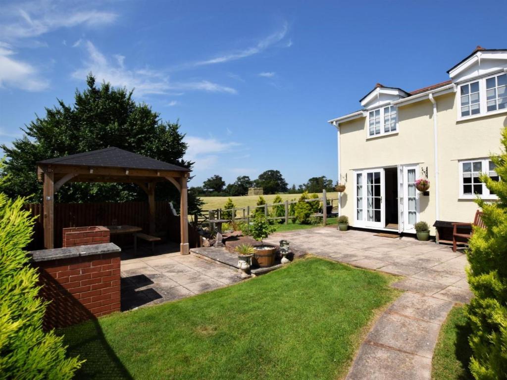 a garden with a patio and a gazebo at 2 Bed in Crediton oc-51275 in Stockleigh Pomeroy