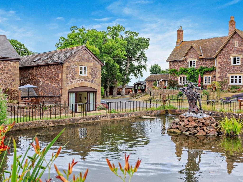 an estate with a pond in front of houses at 3 Bed in Taunton oc-96235 in West Quantoxhead