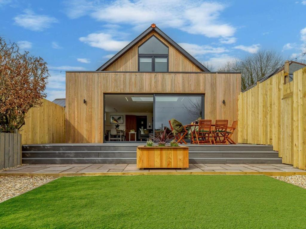 a wooden house with a lawn in front of it at 3 Bed in Holsworthy oc-90721 in Holsworthy