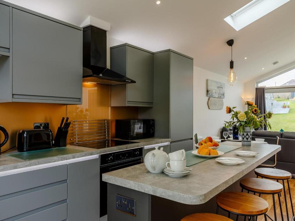 a kitchen with a large counter top with stools at 2 Bed in Brixham oc-78565 in Brixham