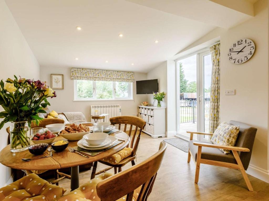 a kitchen and living room with a table and chairs at 2 Bed in Taunton oc-83696 in Thorn Falcon