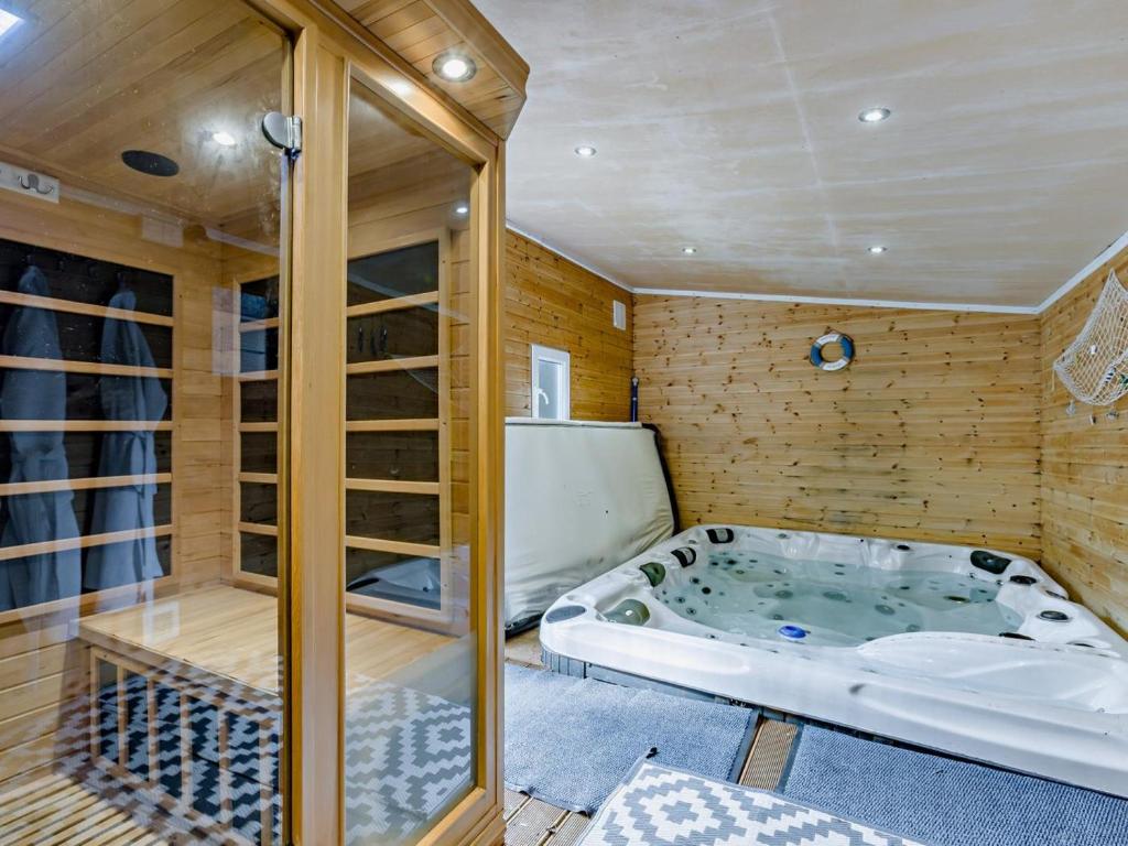 a jacuzzi tub in a room with wooden walls at 4 Bed in Bideford oc-nilga in Bideford