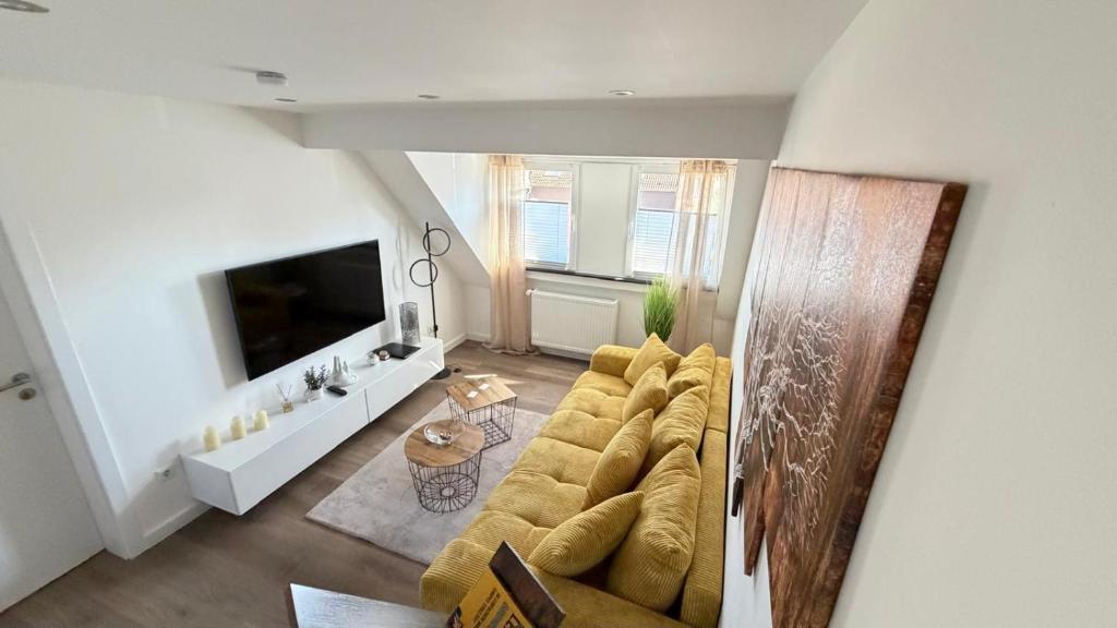 a living room with a couch and a tv at Ferienwohnung Nella in Paderborn