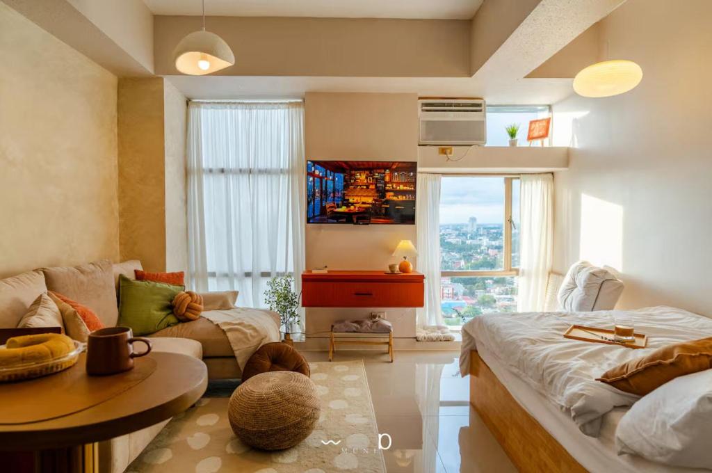 a living room with a couch and a table at Condo in Cubao, Sunset & City Lights Chasing in Manila