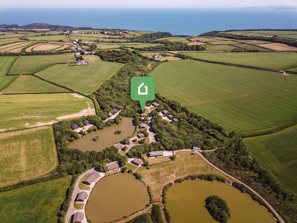 an aerial view of a farm with a green number four at 2 Bed in Bideford oc-00370 in Clovelly