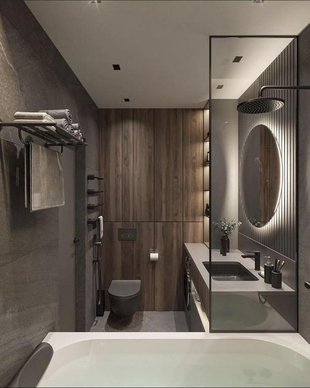 a bathroom with a tub and a toilet and a sink at Amiron Hotel in Dushanbe