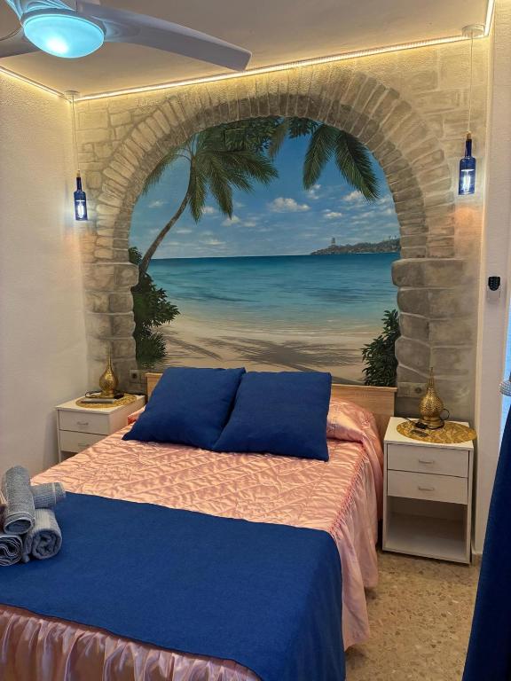 a bedroom with a bed with a view of the ocean at FARO PLAYA in Cullera