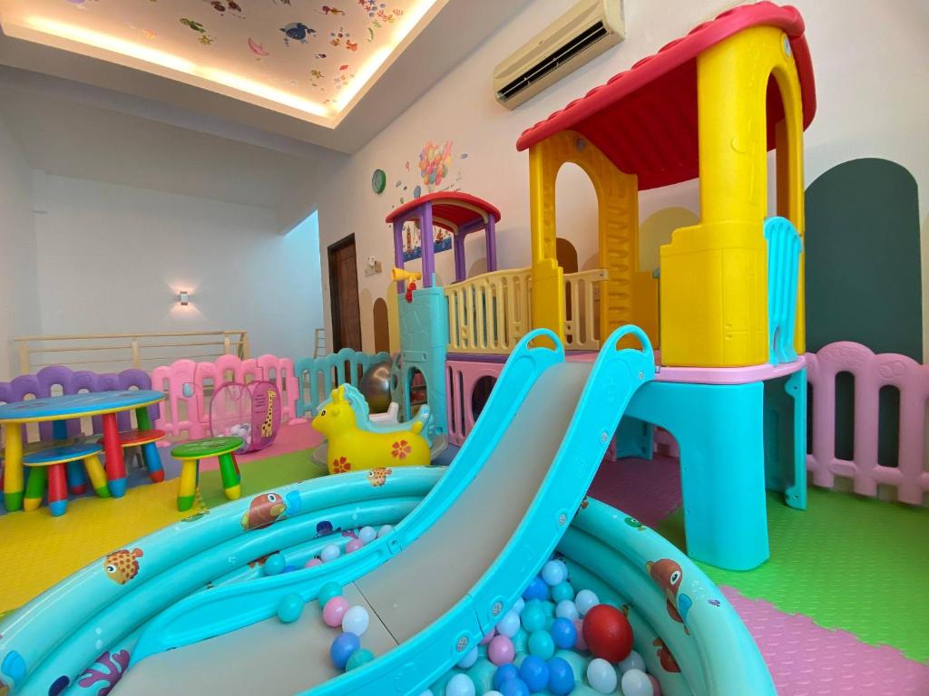 a childs play room with a slide in a play room at Ruma Relaxz by Jeffery Lam Home Management in Malacca