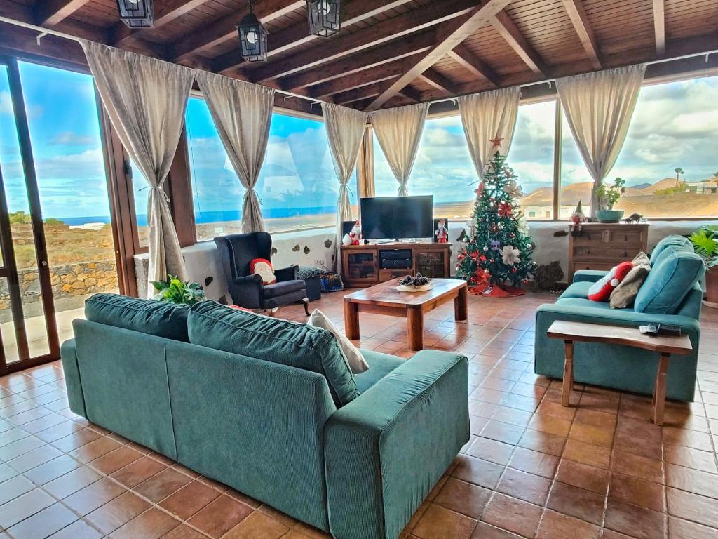 a living room with two couches and a christmas tree at Casa Morro Herreno in Las Breñas