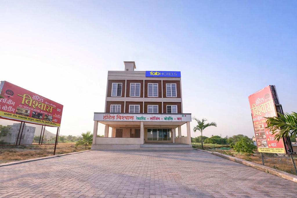 a building on a street with two signs in front of it at FabHotel Vishwas in Aurangabad