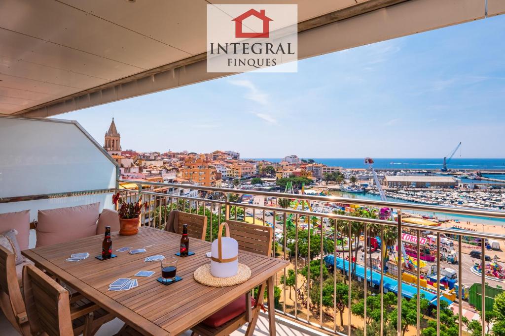 a balcony with a table and a view of the city at Horitzó Marí Palamós in Palamós