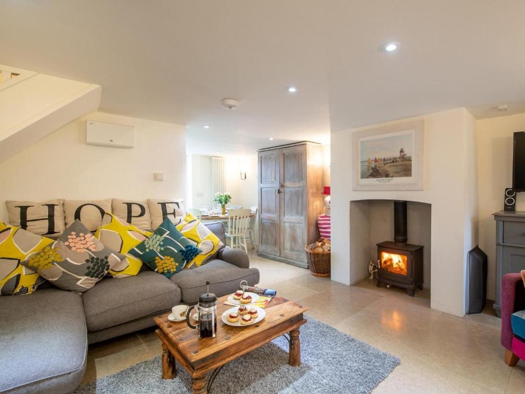 a living room with a couch and a fireplace at 3 Bed in Bridport oc-dc080 in Charmouth