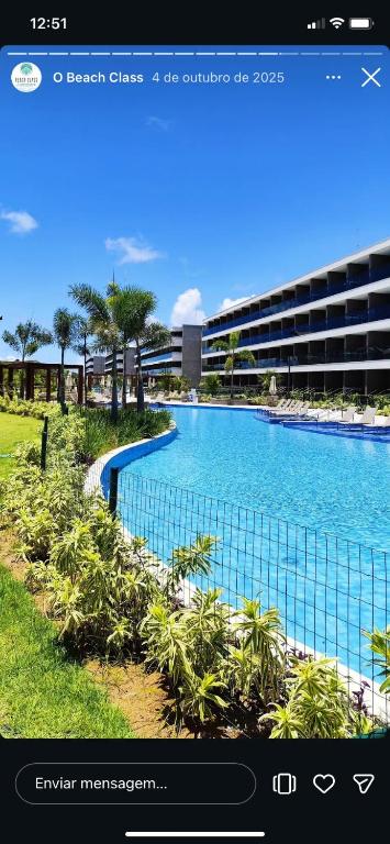 a screenshot of a hotel website with a swimming pool at Beach Class Summer Flat 4 pessoas in Porto De Galinhas