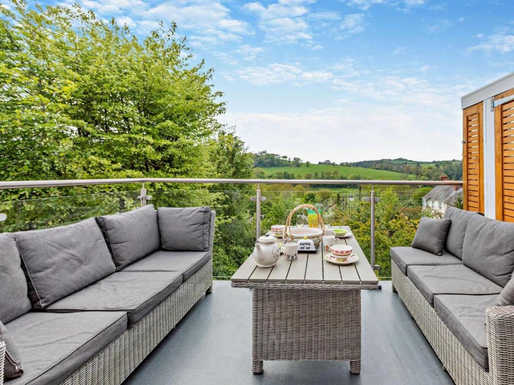 a patio with two couches and a table at 2 Bed in Barnstaple oc-94038 in Bishops Tawton