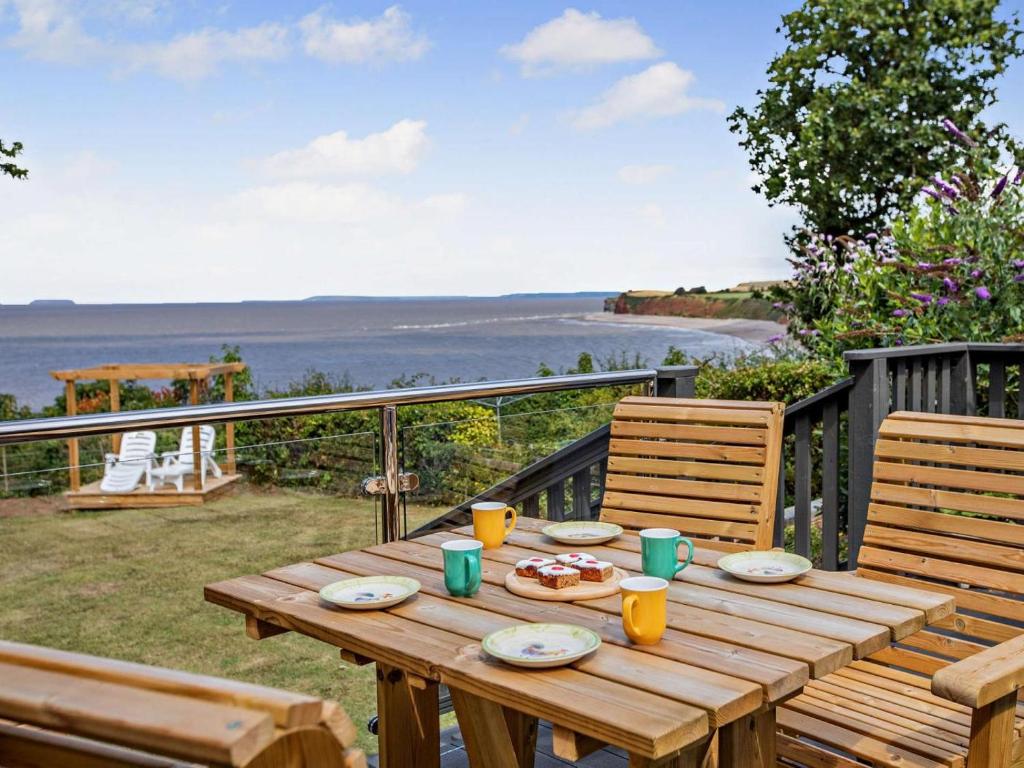 a wooden table with food on top of a balcony at 2 Bed in Taunton oc-96234 in West Quantoxhead