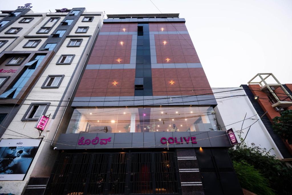 a tall building with a store in front of it at C Suites Gilbert in Bangalore