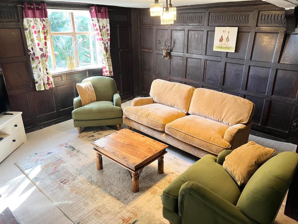 a living room with a couch and two chairs and a table at Habberley Hall Flat in Shrewsbury