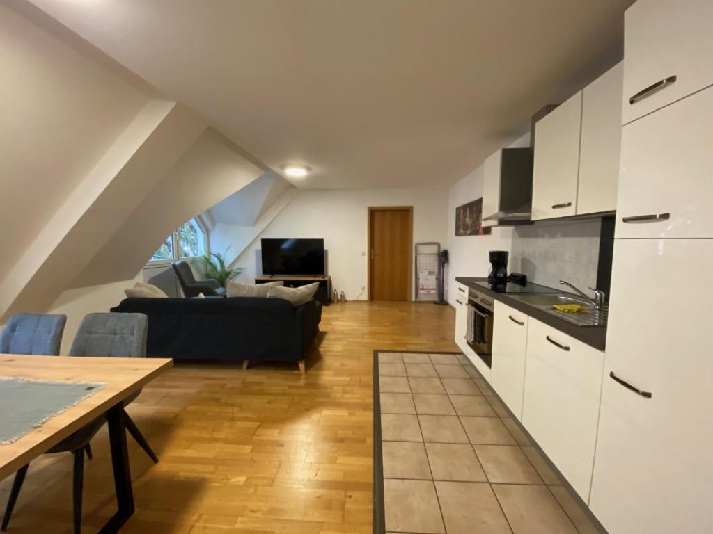 a kitchen and living room with a couch and a table at modern ausgestatte "GS2613" Gästewohnung im Zentrum Merseburgs in Merseburg