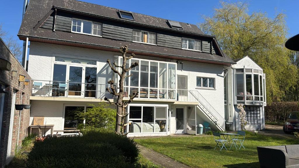 a large house with a tree in front of it at Heavenlywell in Geel