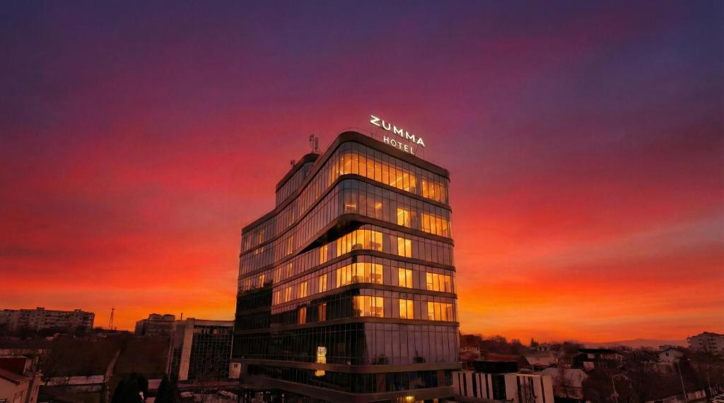 a building with a samsung sign on the top at sunset at ZUMMA Hotel Almaty in Almaty
