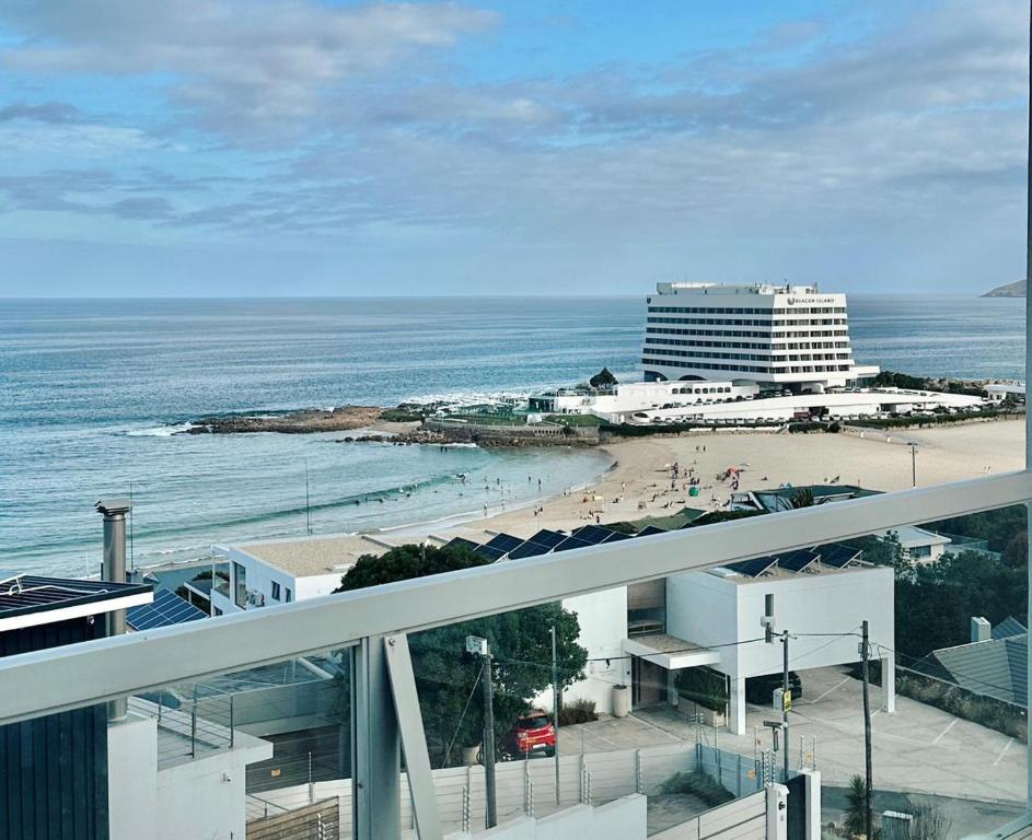 a view of a beach with a hotel and the ocean at Nice Sea View in Plettenberg Bay