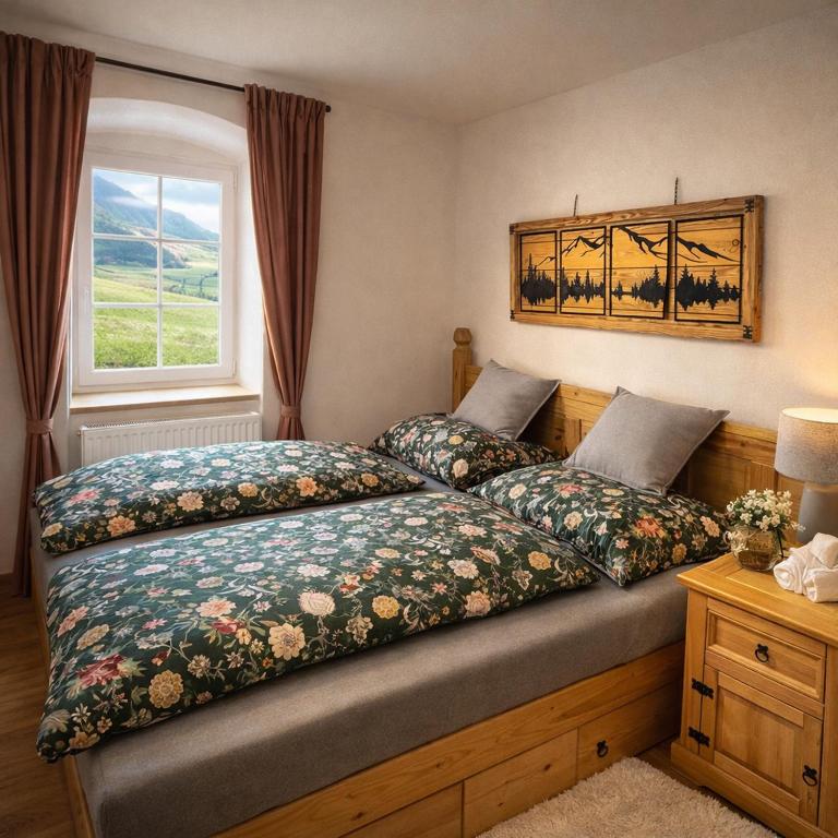 a bedroom with two beds and a window at Bio Hof Bichler in Mariazell