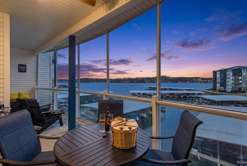 a table on a balcony with a view of the water at 2B 2B Lake View Pool Hot Tub in Lake Ozark